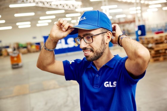 Bărbat care își pune șapca GLS pe cap